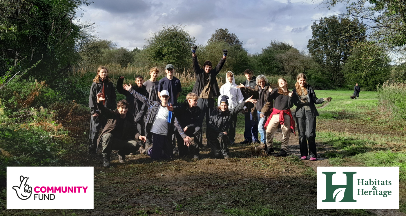Habitats and heritage youth volunteers and staff at Ham Lands with the National Lottery community fund logo and the habitats and heritage logo