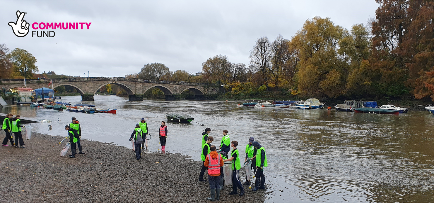 Youth volunteers and Habitats and Heritage staff members litter picking on the foreshore of the River Thames in front of Richmond Bridge